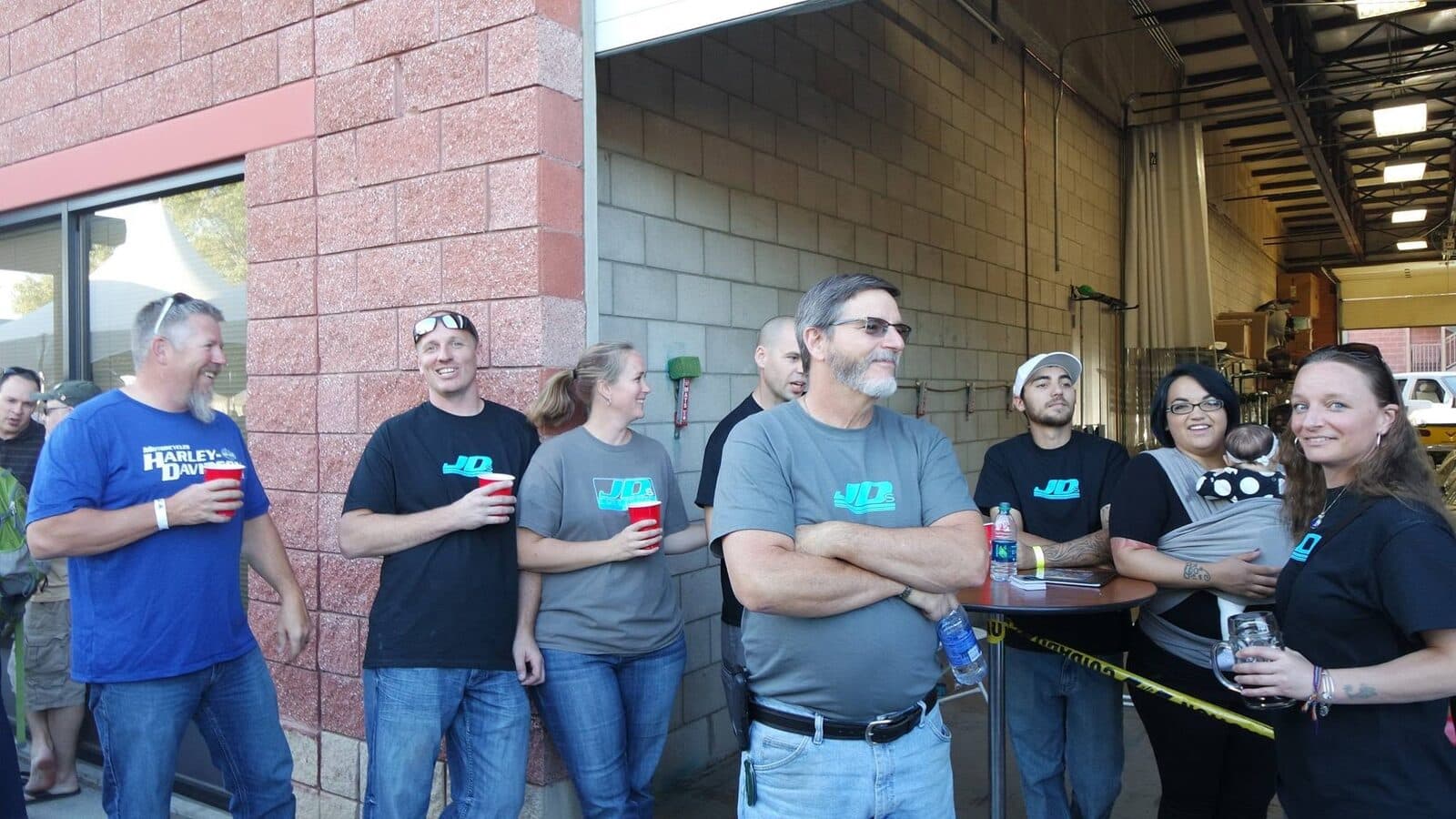 The JDS Collision Repair crew of seven, in branded shirts at the shop